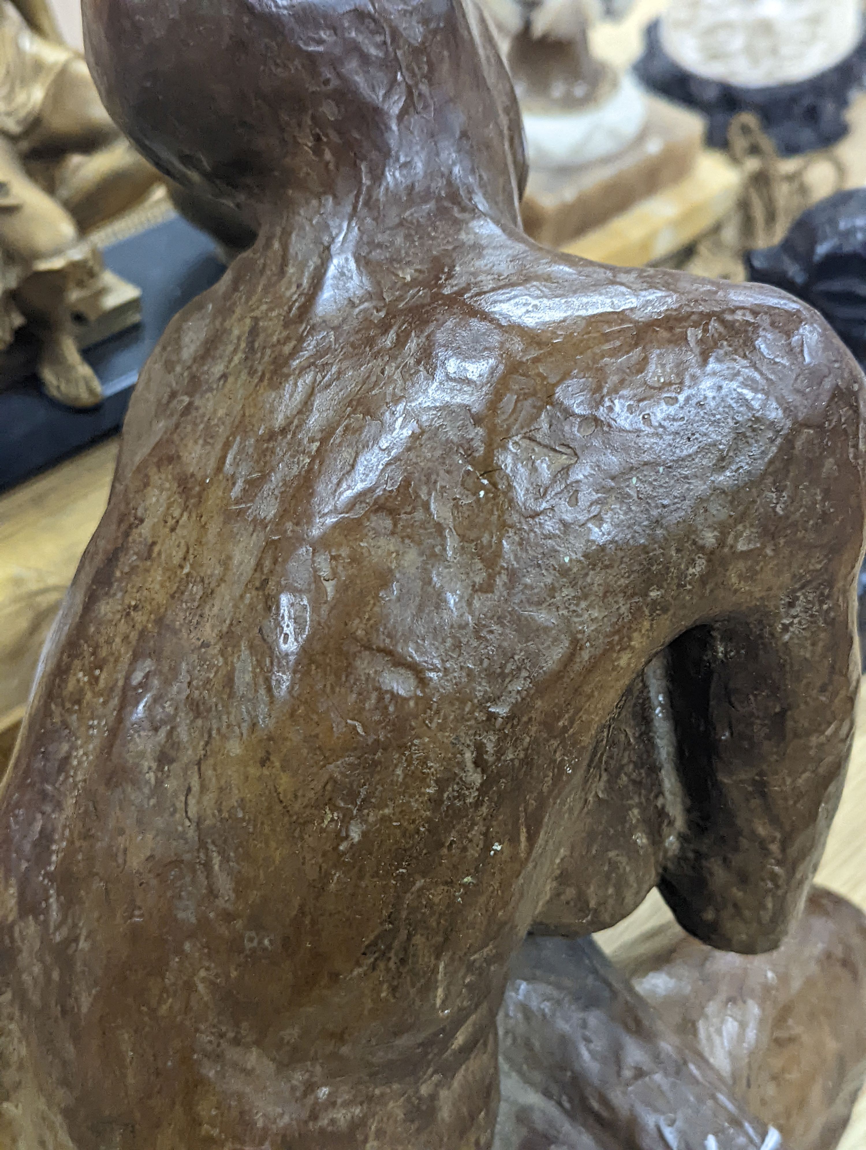 A contemporary bronze of a lady crouching with a thoughtful expression, unsigned - 31cm high